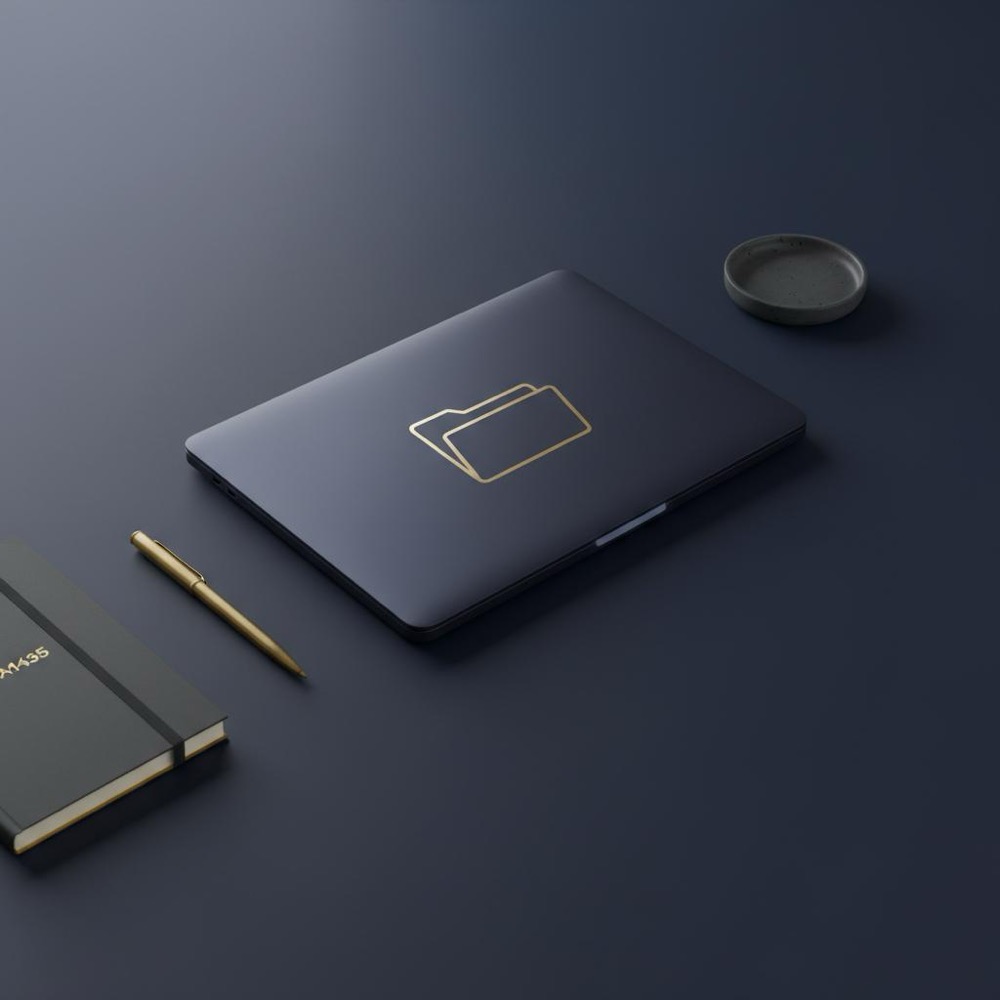 Minimalist tidy workspace with closed laptop and subtle secure folder icon overlay, brass pen and notebook in Orvus Ltd. colors, meta keywords